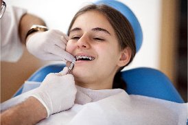 Dentist cleaning braces in Spokane, WA